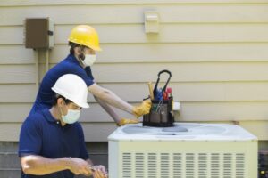 two-techs-working-on-ac-unit